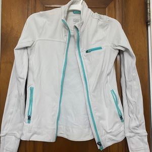 Athleta Girl white fitted sports jacket, blue zippers